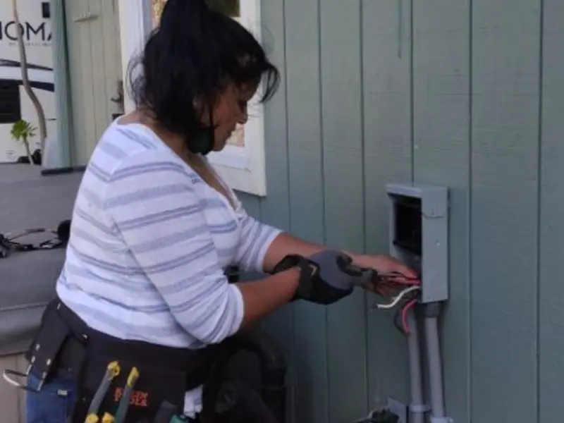 Licensed electrician wiring an exterior subpanel in Brownstown